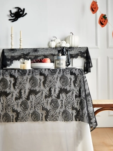 Detailed black lace Halloween tablecloth with cobwebs, bats and Trick or Treat text