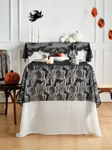Detailed view of Halloween black lace tablecloth and mantle scarf with bat and spider web