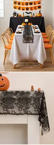 Close-up of Halloween black lace table runner featuring intricate skull and vine patterns