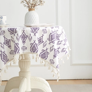 Bohemian purple geometric pattern tablecloth with handmade tassels on a round table