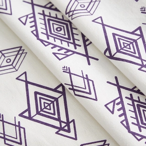 Close-up of diamond pattern cotton linen tablecloth showing soft texture and purple print