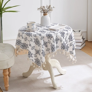 Close-up of bohemian geometric pattern tablecloth with decorative tassel edge detail