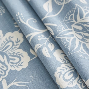 Close-up of blue linen tablecloth with white floral pattern showing weaving texture