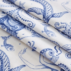 Close-up of mermaid print on linen tablecloth fabric showing texture and detail