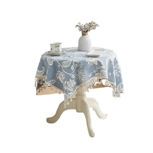 Blue linen round tablecloth with white floral pattern and elegant tassel fringe