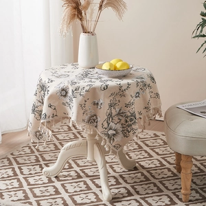 Close-up of ink-wash floral cotton linen tablecloth with delicate fringe tassel edges
