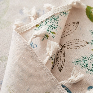 Linen table cloth with green leaf prints and white tassel edges for home decor