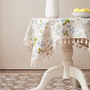 Close-up of green leaf pattern cotton linen tablecloth with elegant fringe edge