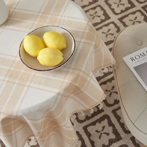 Macro detail of brown plaid cotton linen tablecloth with elegant fringe tassel edge