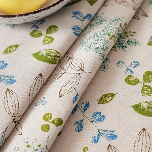 Close-up of cotton linen tablecloth showing thick texture and green leaf print