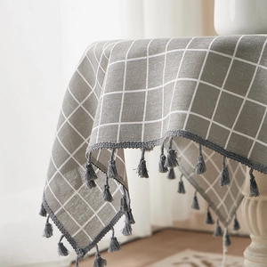 Linen cotton tablecloth with grey and white checkers and elegant tassels for dining tables