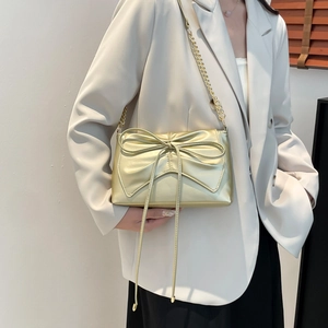 Elegant champagne pearl bow shoulder bag with gold chain strap for minimalist summer style