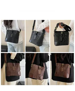 Detailed views of women's bucket bag showing faux snake skin texture and metal buckles