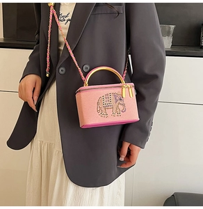 Detail of pink box bag with sparkling rhinestone elephant and gold chain strap