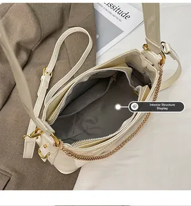 Interior view of cream leather bucket bag with herringbone lining and zippered pocket