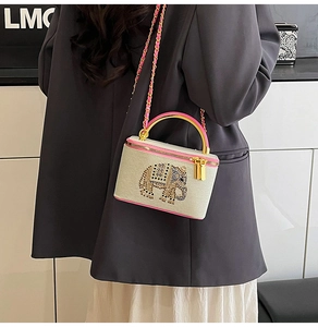 Detailed view of the mini box bag with rhinestone elephant pattern and chain strap