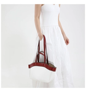 Detailed view of the dual-handle design on a minimalist cream and burgundy tote bag