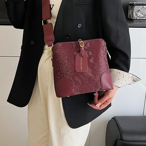 Burgundy bucket bag with snake-embossed pattern and wide strap for women