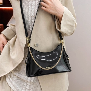 Glossy black patent leather underarm bag with gold chain and fashion lettering