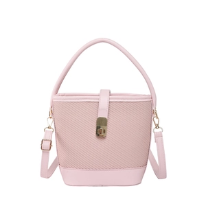 Pink patchwork woven bucket bag with leather handles and gold metal twist lock closure