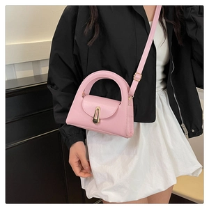 Pink PU leather handbag detail with semi-circular hollow handle and gold metal lock