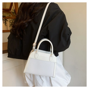 Detail of white woven tote bag with adjustable strap and Fashion & Bags embossed logo
