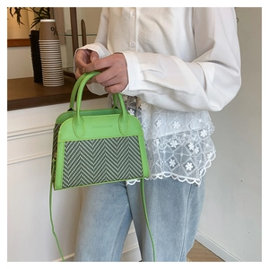 Detail of green leather handbag with wavy woven pattern and Fashion & Bags embossing