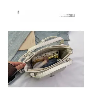 Detailed top view of a white pebble leather bucket bag showing its spacious interior compartment