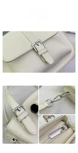 Macro detail of cream lychee leather texture and silver lobster clasp hardware on bucket bag