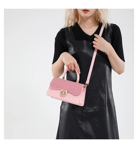 Pink patchwork crossbody bag with gold lock buckle and diamond texture shown on model
