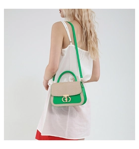 Detail of green leather and woven texture tote bag with golden double-ring twist lock