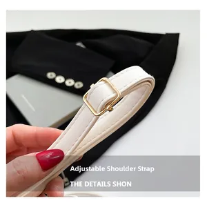 Detail of white PU leather adjustable shoulder strap with golden square metal buckle