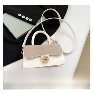 Detail showing white faux leather bag with brown woven texture and gold metal turn lock