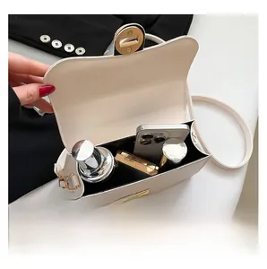 Detail showing the internal capacity of the beige handbag with smartphone and cosmetics