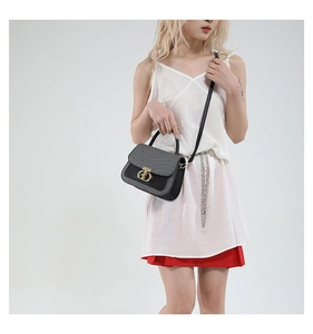 Detail of tweed and leather crossbody bag with golden CD logo clasp and top handle