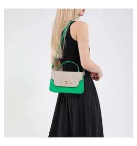 Detail of trendy green leather and beige tweed patchwork crossbody bag with gold buckle