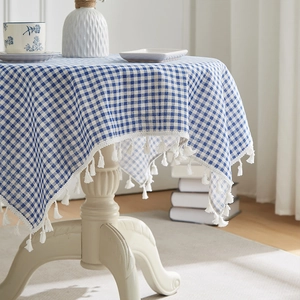 Blue and white plaid cotton linen tablecloth with white tassel edge on round table