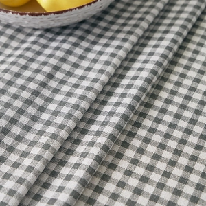 Close-up of gray gingham cotton linen fabric with a textured weave for table decor