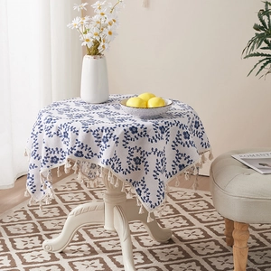 Floral cotton linen tablecloth with blue vine patterns and cream fringe tassels detail