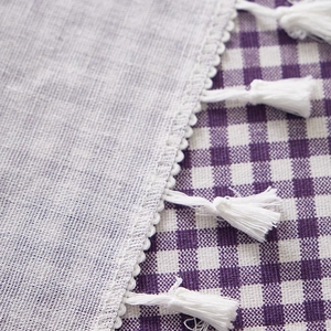 Linen checkered tablecloth with delicate white lace edges and handmade tassels for home