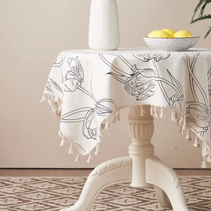 Close-up of tulip print cotton linen tablecloth with elegant cotton fringe tassels