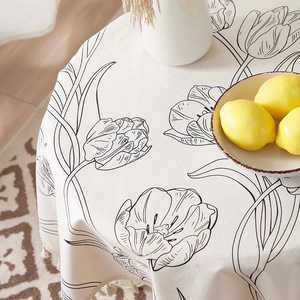 Tulip pattern linen cotton tablecloth with tassels on a round dining table