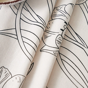 Close-up of minimalist tulip linen tablecloth with elegant black line art pattern