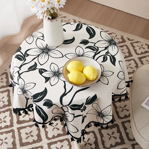 Linen cotton round tablecloth with large black floral patterns and tassel edges