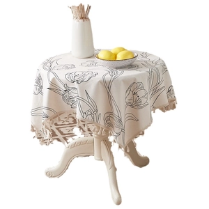 Minimalist cotton linen tulip tablecloth with fringes on a round dinner table