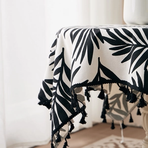Tropical palm leaf print tablecloth with elegant black tassel fringe decorations