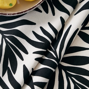 Detail of tropical palm leaf pattern on thick cotton linen fabric with fresh decor