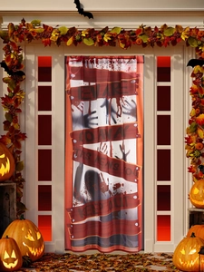 Detail of Halloween door curtain with bloody handprints and beware warning signs