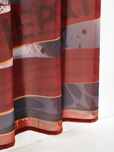 Macro detail of breathable mesh dress hem featuring artistic red and blue abstract print