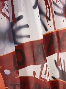 Detail of Halloween door curtain fabric with bloody handprints and NO AWAY text